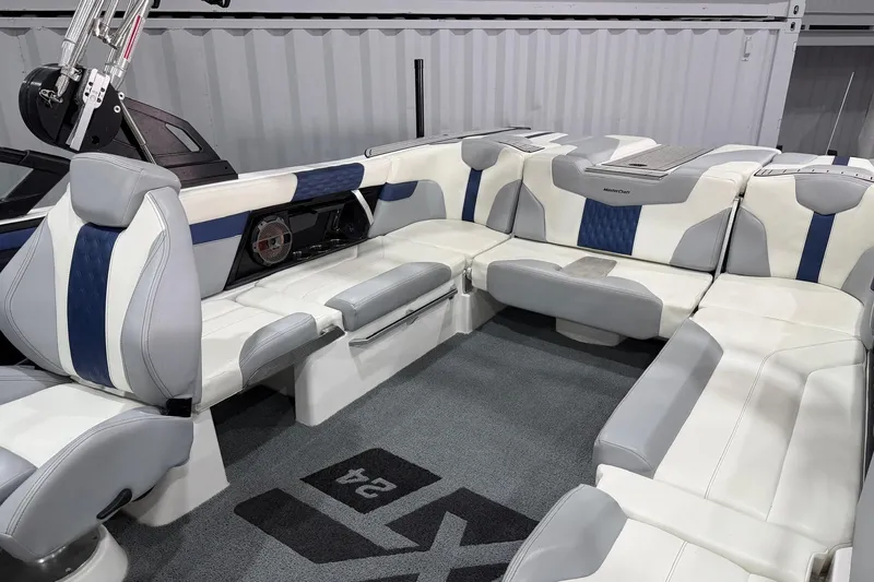 Slide: The Image of 2022 MasterCraft XT24 boat interior with luxurious white and blue seating. - 9