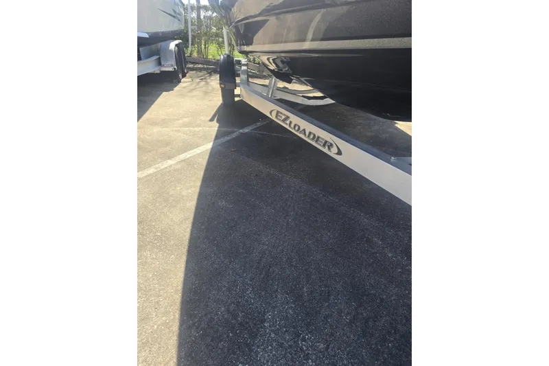 Slide: The Image of 2006 Triton Tr-176 boat on EZ Loader trailer in parking lot. - 10