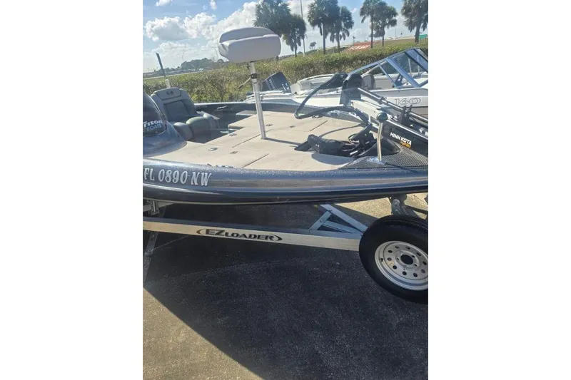 Slide: The Image of 2006 Triton Tr-176 boat on EZ Loader trailer, parked outdoors under sunny skies. - 4