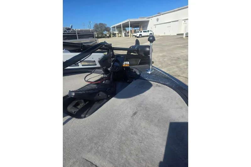 Slide: The Image of 2006 Triton Tr-176 boat deck with trolling motor in a sunny outdoor setting. - 5
