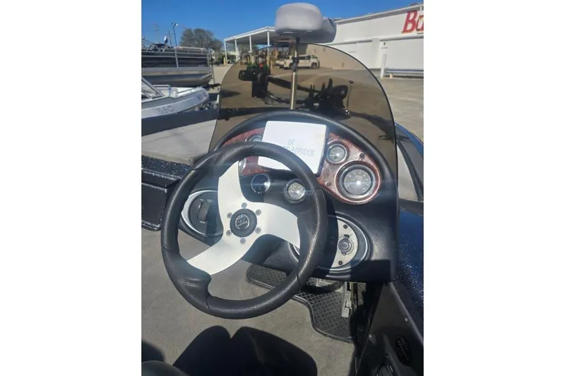 Slide: The Image of 2006 Triton Tr-176 boat dashboard with steering wheel and gauges. - 8