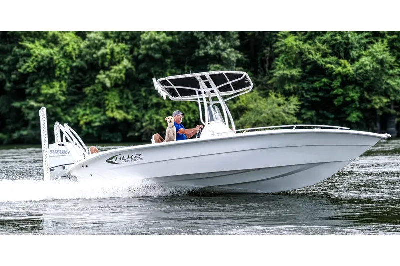 The Image of 2026 ALK2 23 CRX boat cruising on a river with a person and dog onboard. - 1