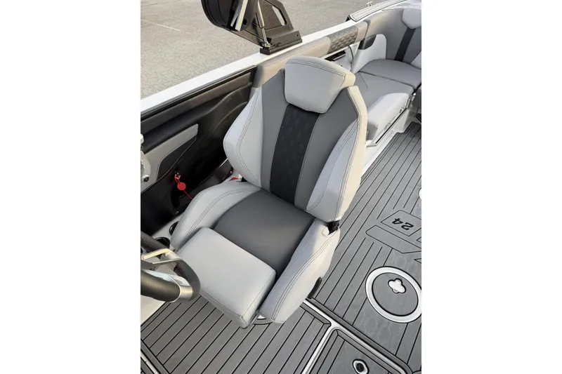 Slide: The Image of 2023 MasterCraft XT24 boat interior with sleek gray seating and modern design. - 16