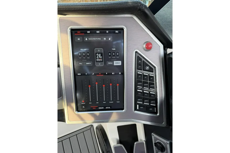 Slide: The Image of 2023 MasterCraft XT24 boat control panel with touchscreen and buttons. - 18