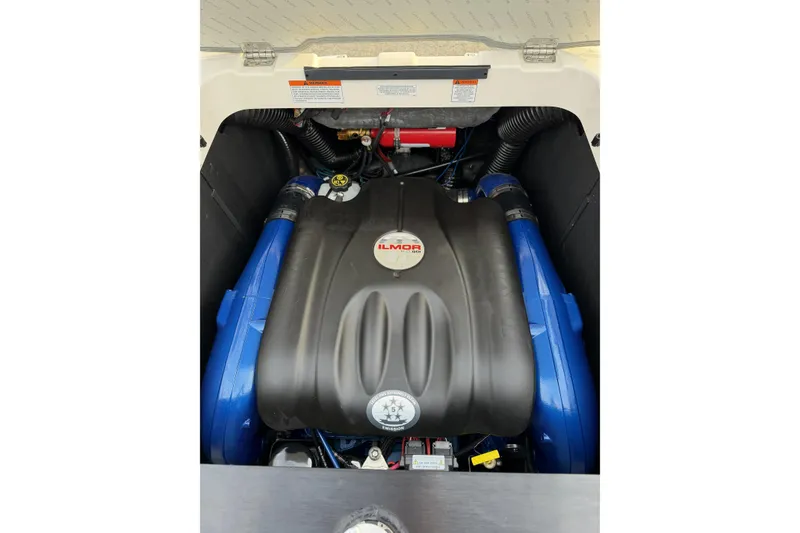 Slide: The Image of 2023 MasterCraft XT24 engine compartment featuring Ilmor engine components. - 19