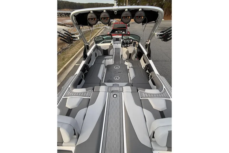 Slide: The Image of 2023 MasterCraft XT24 boat interior with sleek gray seating and advanced audio system. - 9