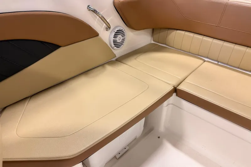 Slide: The Image of 2018 Sea Ray SPX 210 boat interior seating with tan and brown upholstery. - 10