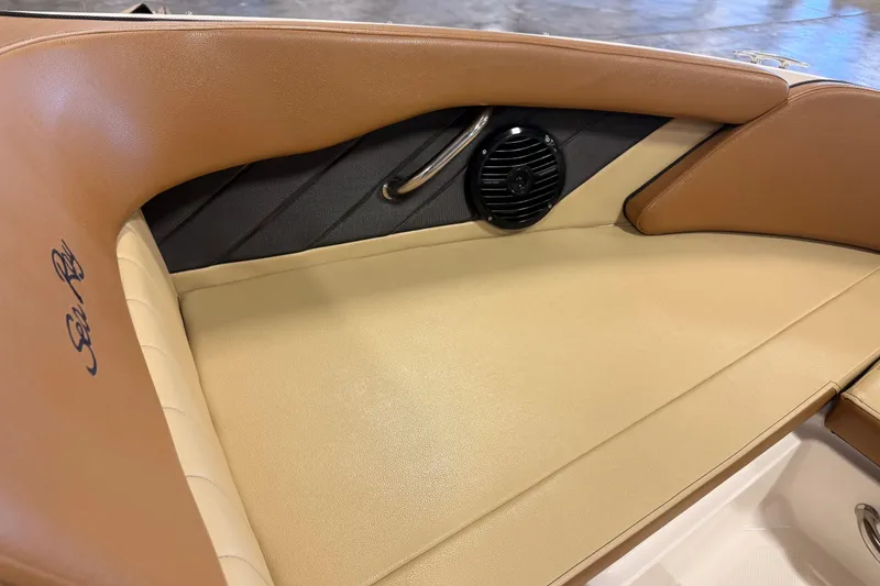 Slide: The Image of 2018 Sea Ray SPX 210 boat interior with tan leather seating and speaker detail. - 15