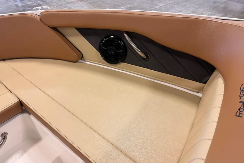 Slide: The Image of 2018 Sea Ray SPX 210 boat interior with tan leather seating and speaker detail. - 16