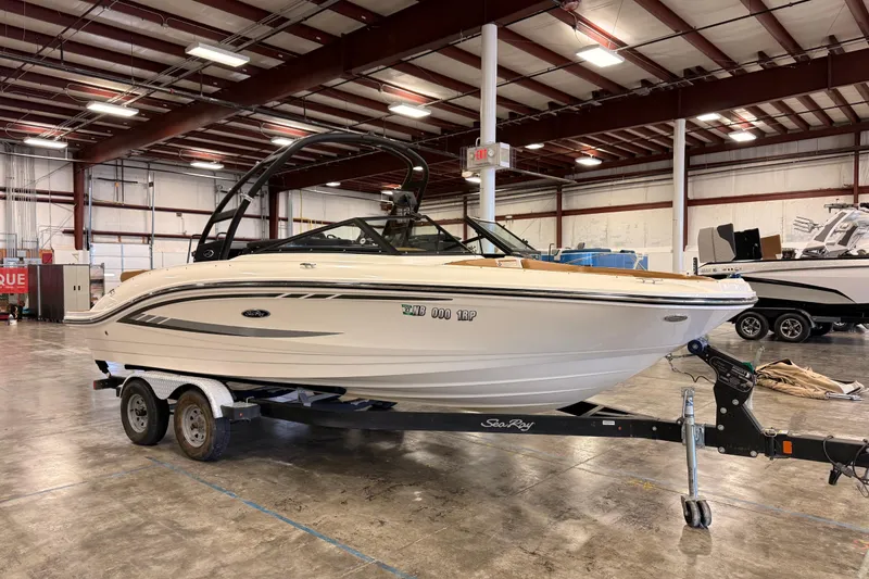Slide: The Image of 2018 Sea Ray SPX 210 boat on trailer in indoor storage facility. - 3