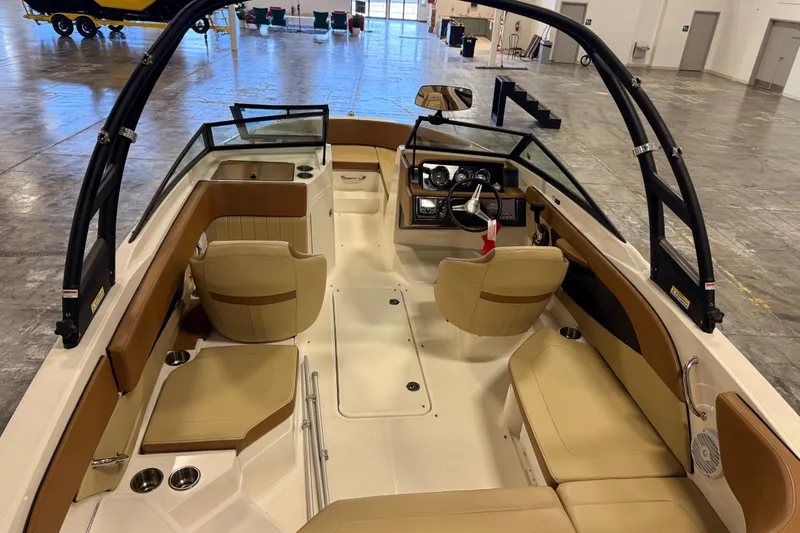 Slide: The Image of 2018 Sea Ray SPX 210 boat interior with tan seating and modern dashboard. - 7