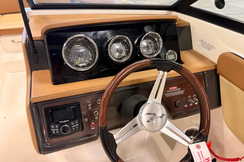 Slide: The Image of 2018 Sea Ray SPX 210 dashboard with gauges and steering wheel. - 8