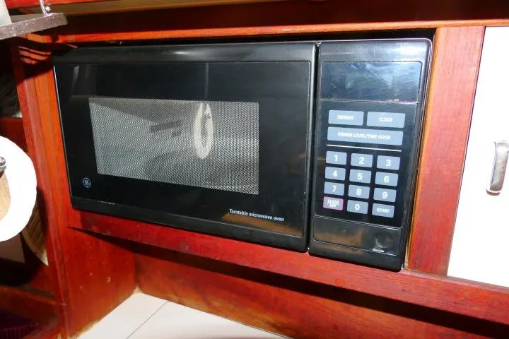 Slide: The Image of Built-in microwave oven on 1989 Catalina 34 yacht, featuring digital keypad and wood cabinetry. - 18