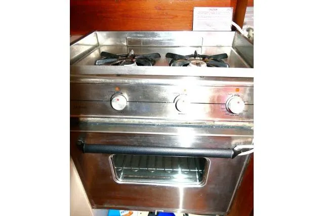 Slide: The Image of Stainless steel stove and oven in a 1989 Catalina 34 yacht kitchen. - 19