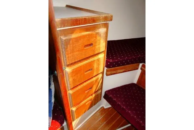 Slide: The Image of Wooden drawers and seating inside a 1989 Catalina 34 sailboat cabin. - 23
