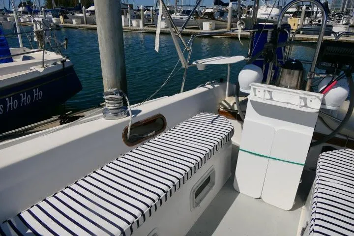 Slide: The Image of 1989 Catalina 34 sailboat with striped seating, docked at a marina. - 31