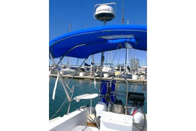 Slide: The Image of 1989 Catalina 34 sailboat with blue canopy and Garmin radar in marina. - 37