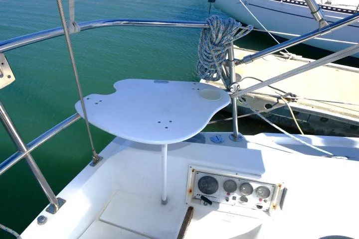 Slide: The Image of Cockpit of 1989 Catalina 34 sailboat with steering controls and docked at marina. - 38