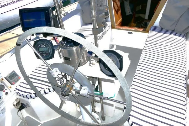 Slide: The Image of Cockpit of 1989 Catalina 34 sailboat with striped cushions and navigation instruments. - 40