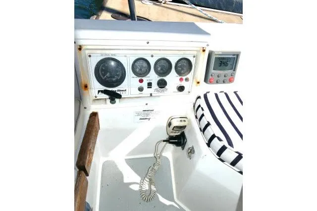 Slide: The Image of Control panel of a 1989 Catalina 34 sailboat with gauges and striped cushion. - 44
