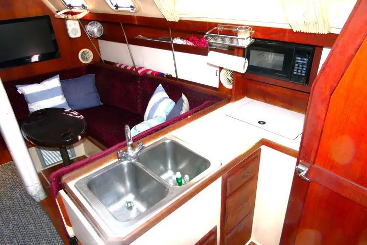 Slide: The Image of Interior of a 1989 Catalina 34 sailboat with kitchen and seating area. - 5