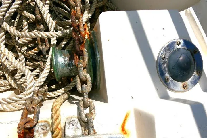 Slide: The Image of Rope and chain on 1989 Catalina 34 boat deck, showing wear and rust. - 56