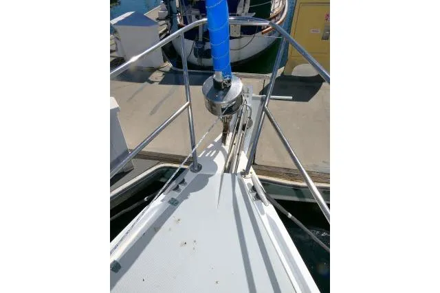 Slide: The Image of Bow of 1989 Catalina 34 sailboat docked, featuring stainless steel railings and anchor system. - 57