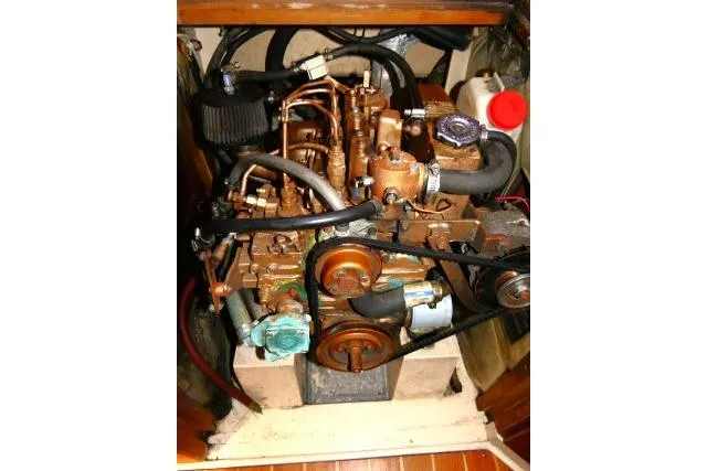 Slide: The Image of Engine compartment of a 1989 Catalina 34 sailboat, showcasing mechanical components and hoses. - 67