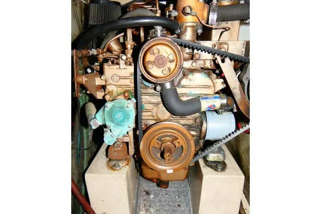 Slide: The Image of 1989 Catalina 34 engine, detailed view of mechanical components and belts. - 69