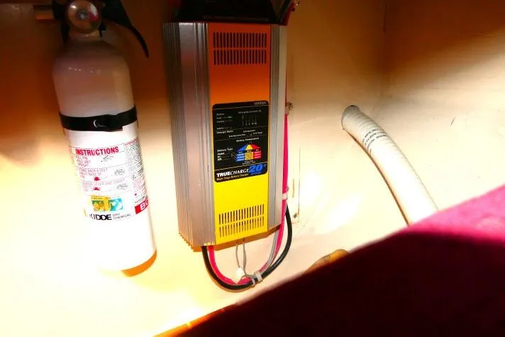 Slide: The Image of Fire extinguisher and battery charger in 1989 Catalina 34 boat interior. - 72