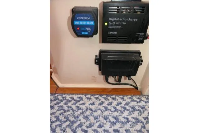 Slide: The Image of Battery chargers and electrical components in a 1989 Catalina 34 boat interior. - 73