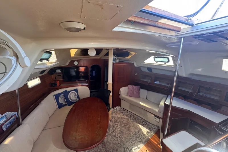 Slide: The Image of Interior of 1992 Hunter Passage 42 yacht with cozy seating and wooden table. - 102
