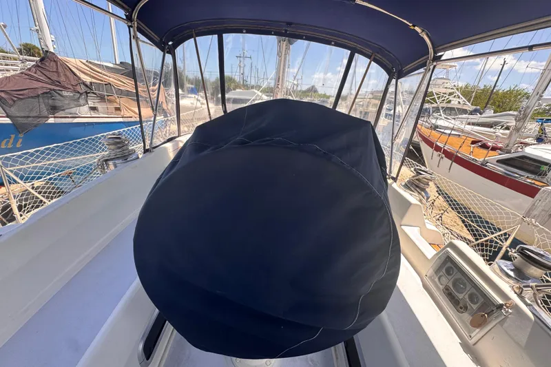 Slide: The Image of Cockpit view of a 1992 Hunter Passage 42 sailboat with covered steering wheel. - 104