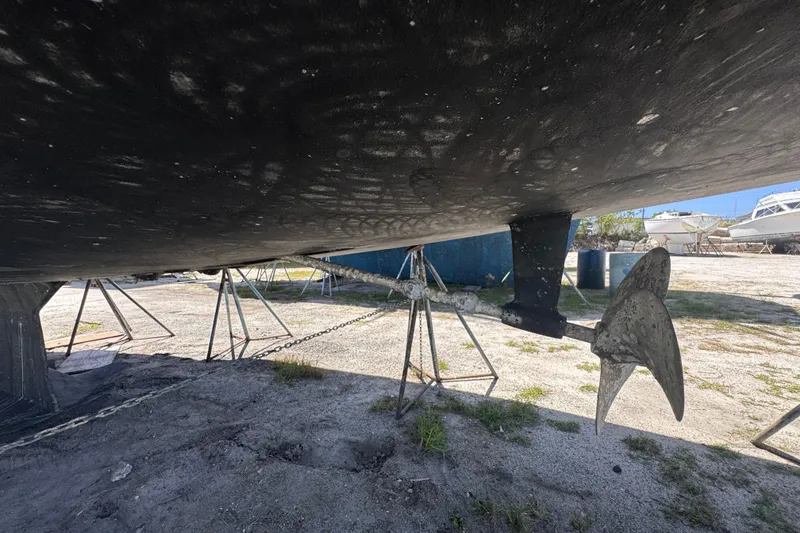 Slide: The Image of Underneath view of a 1992 Hunter Passage 42 sailboat on stands, showing the propeller and keel. - 19