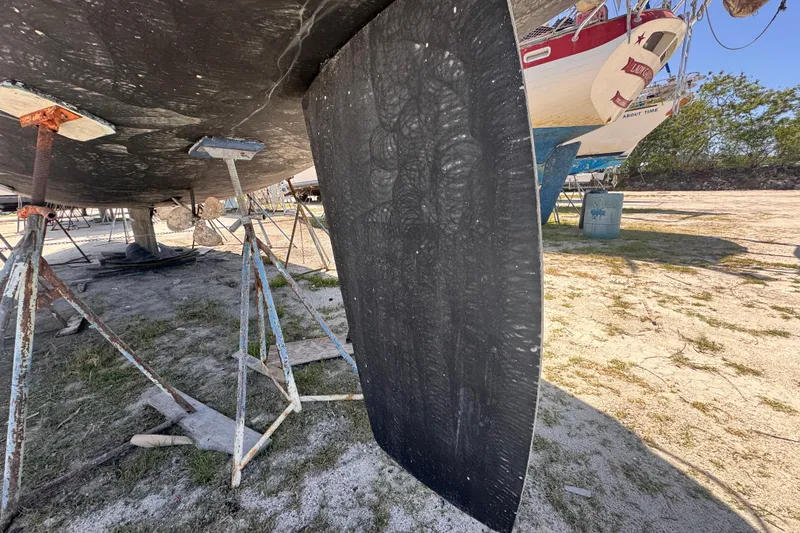 Slide: The Image of Hunter Passage 42 sailboat from 1992 on stands, showing keel and propeller. - 23