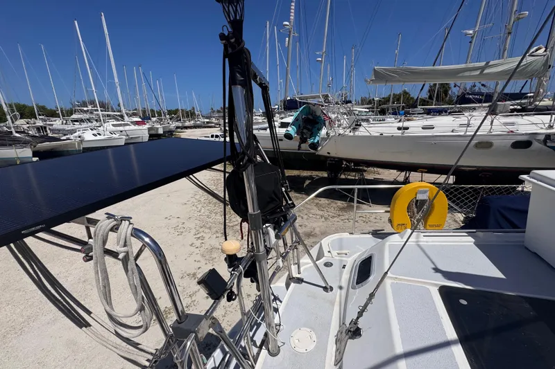 Slide: The Image of Hunter Passage 42 sailboat from 1992 in a marina, surrounded by other boats. - 25