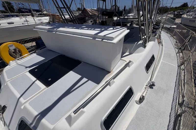 Slide: The Image of 1992 Hunter Passage 42 sailboat deck with steering wheel and safety netting. - 26