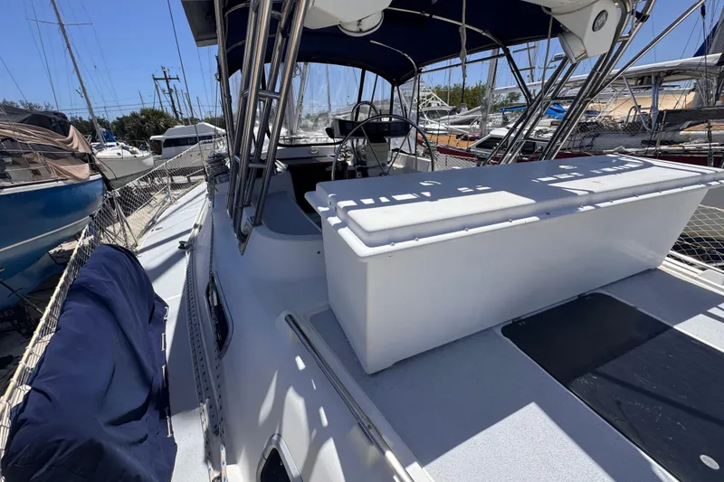 Slide: The Image of 1992 Hunter Passage 42 sailboat deck with steering wheel and canopy in marina. - 28