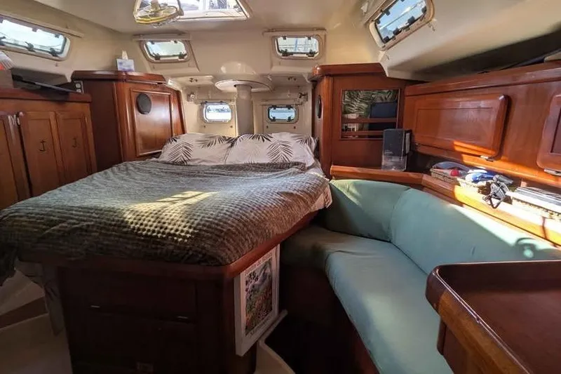 Slide: The Image of Cozy interior of 1992 Hunter Passage 42 sailboat with bed and seating area. - 3