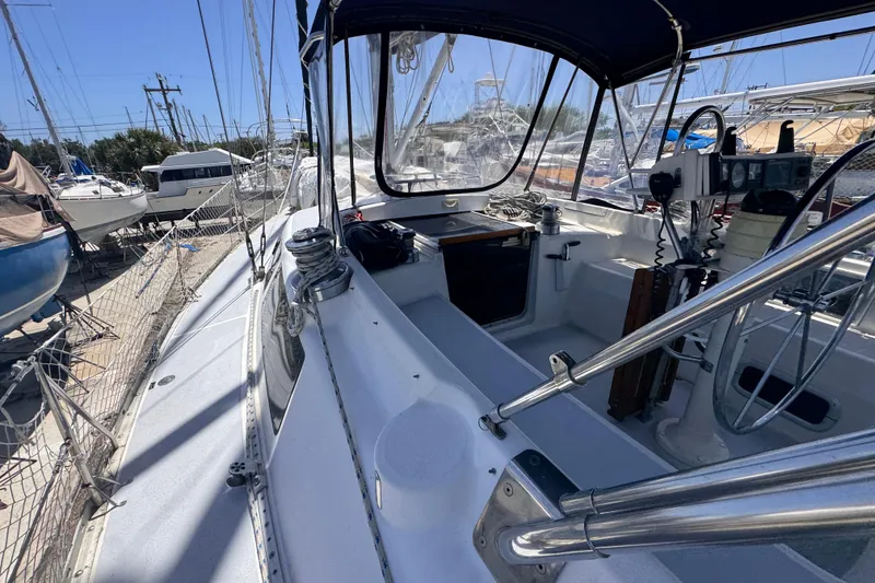 Slide: The Image of 1992 Hunter Passage 42 sailboat cockpit with steering wheel and navigation equipment. - 30