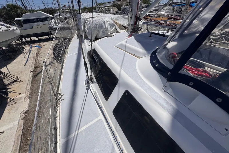 Slide: The Image of Hunter Passage 42 sailboat deck, 1992 model, in a marina with other boats. - 32