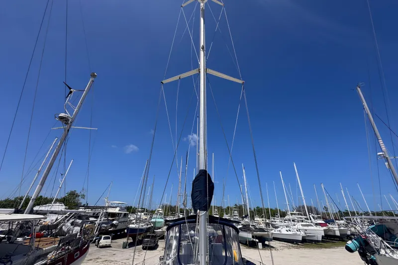 Slide: The Image of Sailboats docked under clear blue sky, featuring a 1992 Hunter Passage 42. - 38