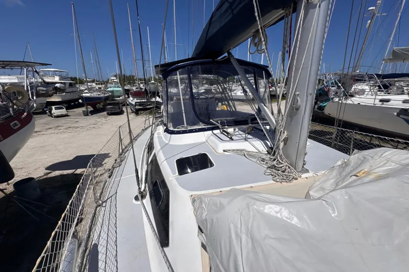 Slide: The Image of 1992 Hunter Passage 42 sailboat docked in a marina, surrounded by other vessels. - 49