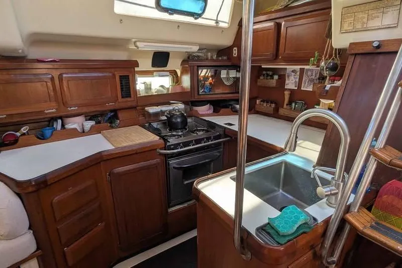 Slide: The Image of Interior of 1992 Hunter Passage 42 sailboat kitchen with wooden cabinetry and stainless steel sink. - 5