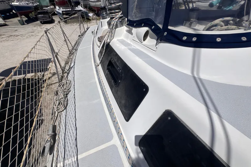 Slide: The Image of Side deck view of a 1992 Hunter Passage 42 sailboat in a marina. - 51