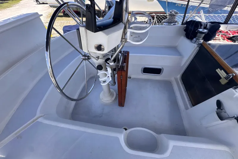 Slide: The Image of Cockpit of 1992 Hunter Passage 42 sailboat with steering wheel and seating area. - 54