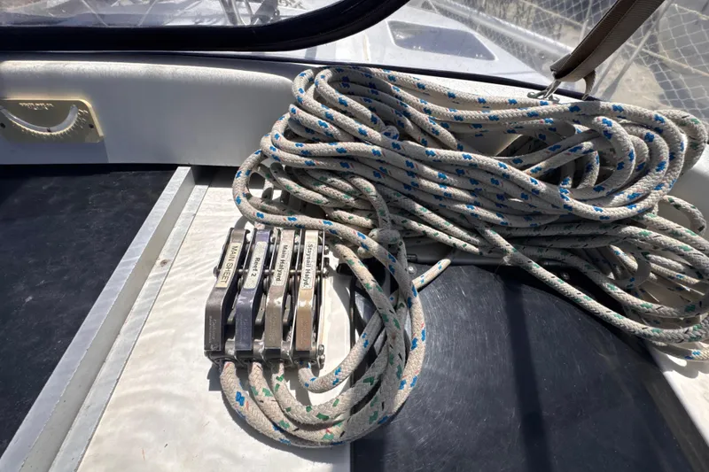 Slide: The Image of Coiled ropes and cleats on a 1992 Hunter Passage 42 sailboat deck. - 60