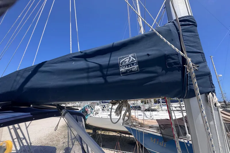 Slide: The Image of 1992 Hunter Passage 42 sailboat with Doyle sail cover, docked in a marina under clear blue sky. - 65
