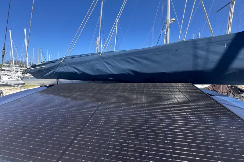 Slide: The Image of Hunter Passage 42 sailboat with solar panels, docked at a marina under clear blue skies. - 67