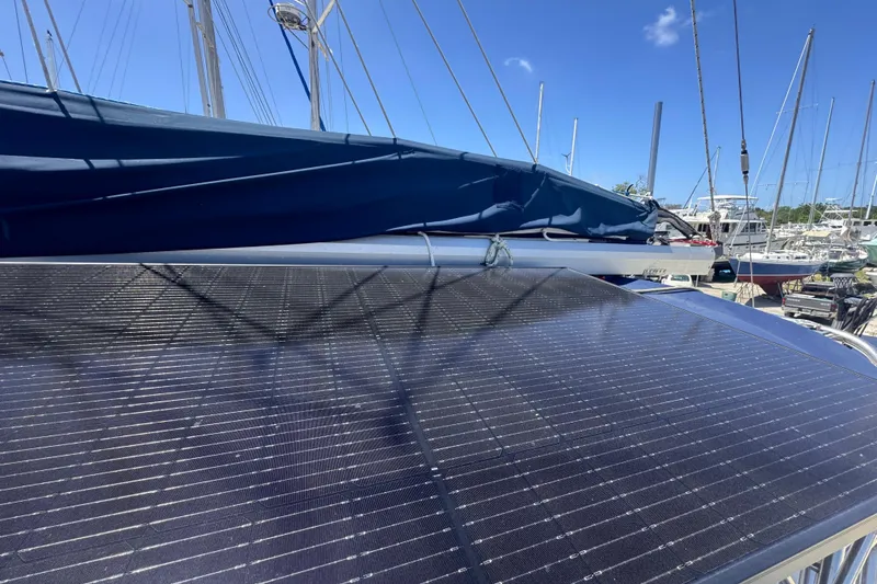 Slide: The Image of Solar panels on a 1992 Hunter Passage 42 sailboat under a clear blue sky. - 68